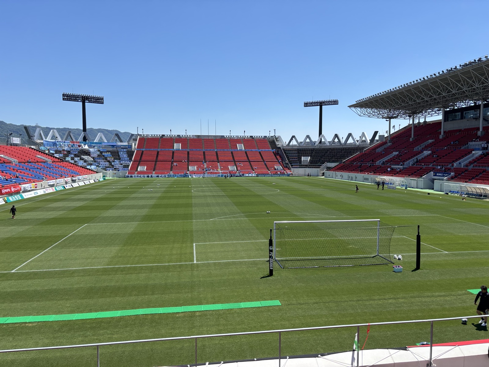 試合前の花園ラグビー場ピッチ全景 観客席は赤と紺のラグビー仕様