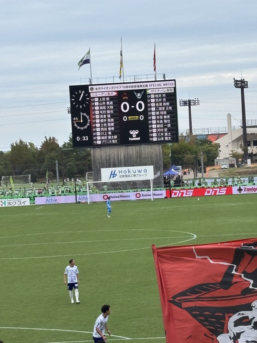 大型ビジョンに表示されたキックオフ直前0-0のスコアボードとスターティングメンバー